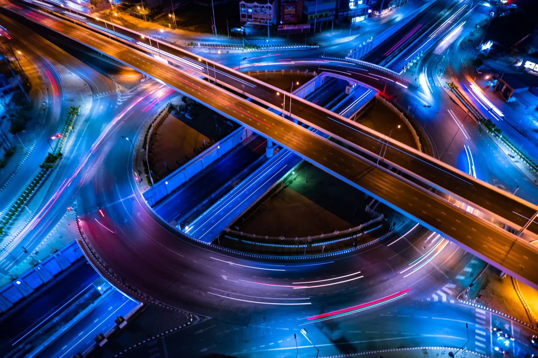 Light trails circling a roundabout at night